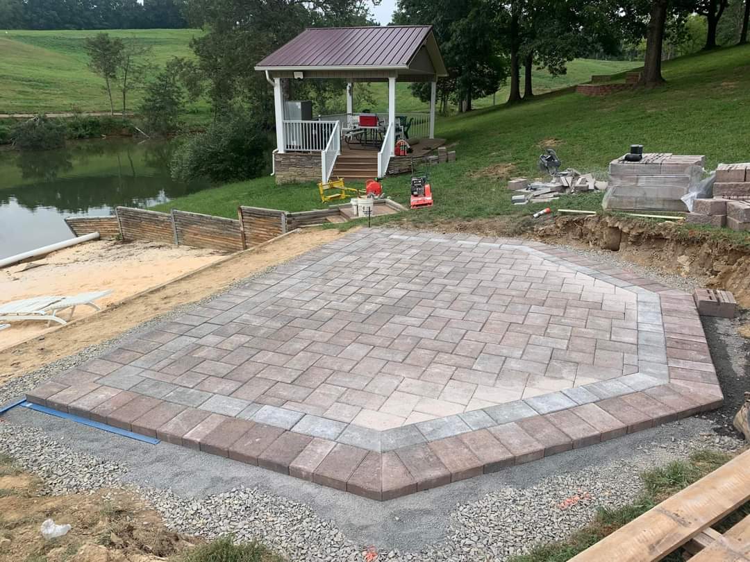 Lakeside paver patio near completion with gazebo