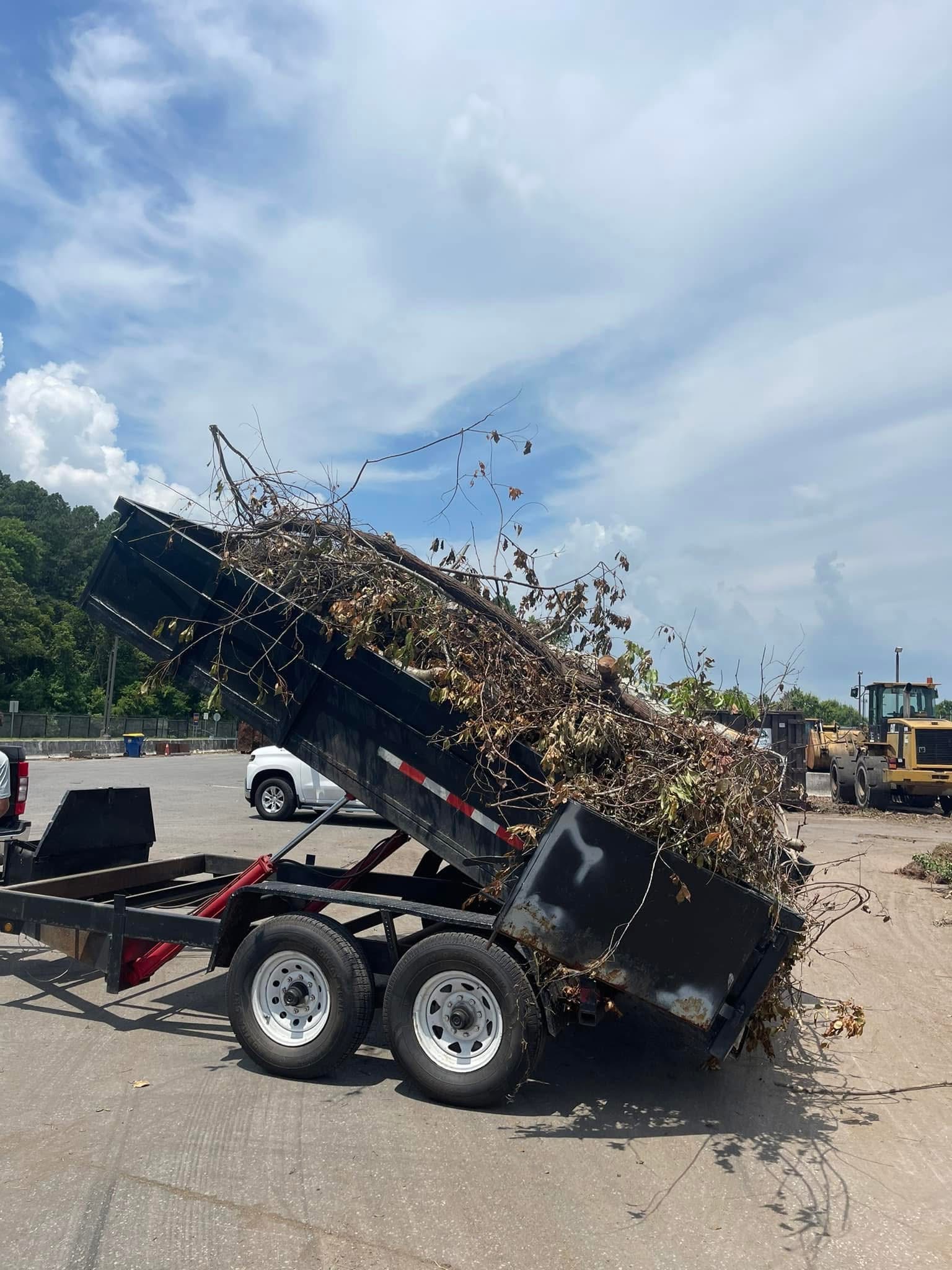 Dump trailer hauling debris from land clearing job