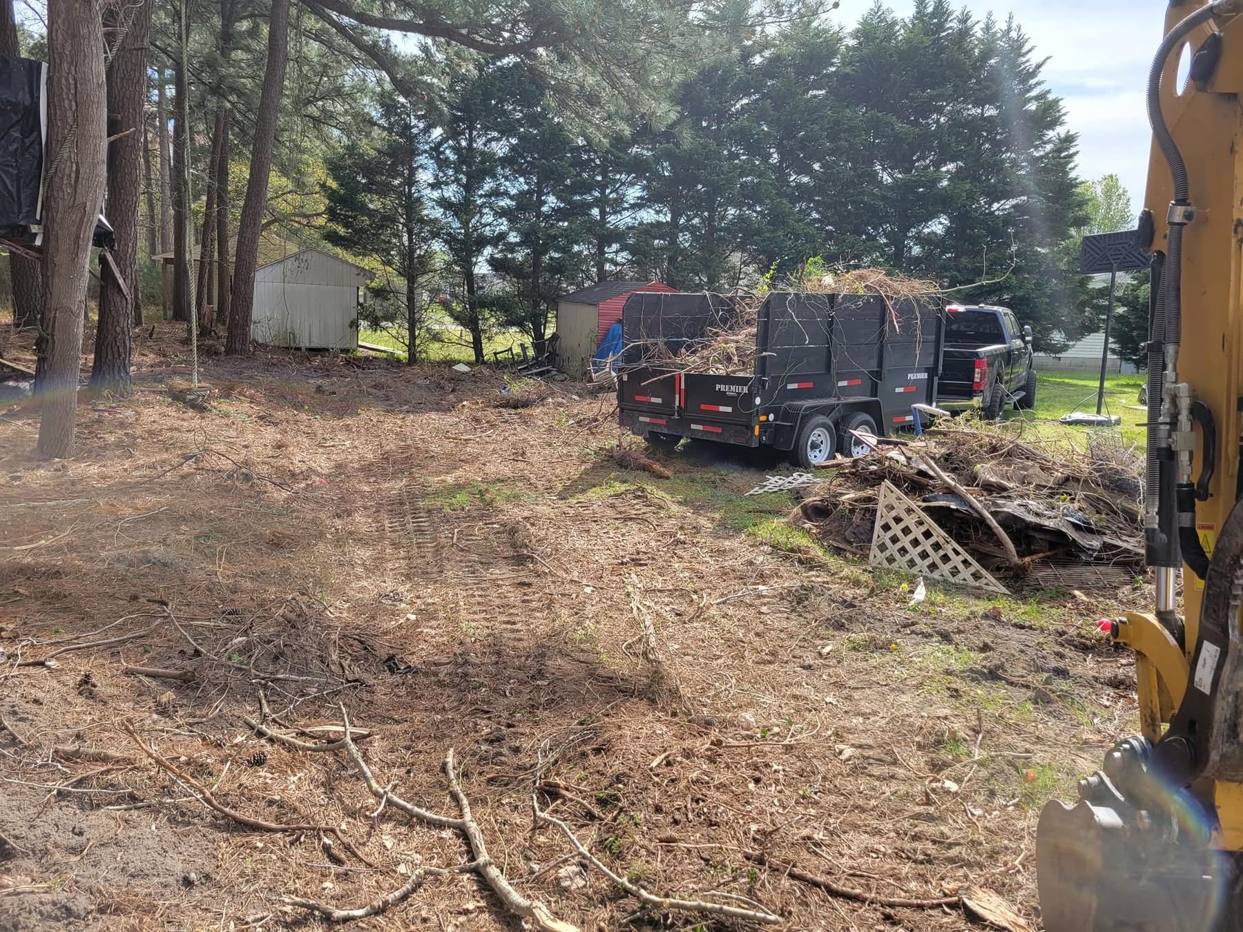 Excavation and land clearing with excavator and trailer