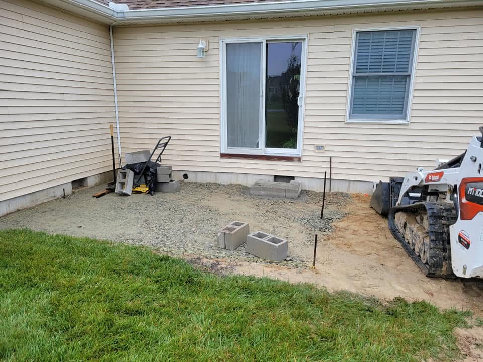 Patio area prepped with gravel base and skid steer